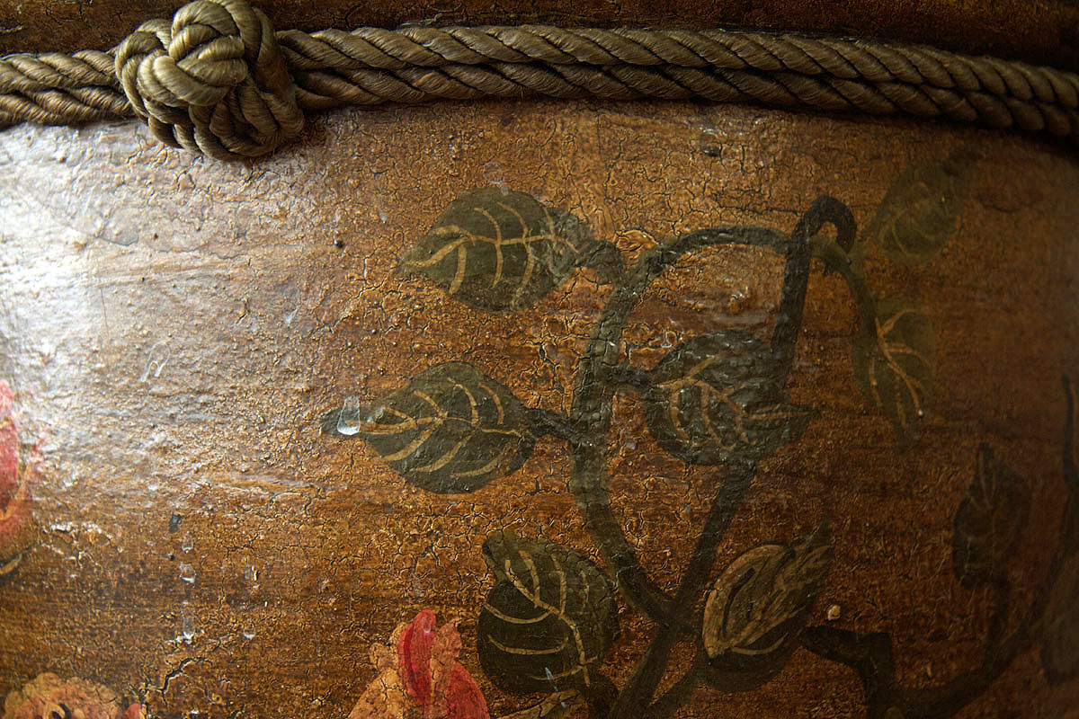 A painted vine motif with rope trim on a gilded surface