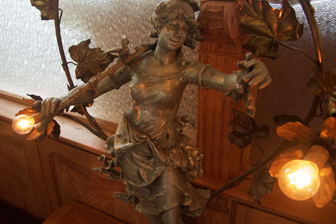 A figural bronze lamp with amber glass shades