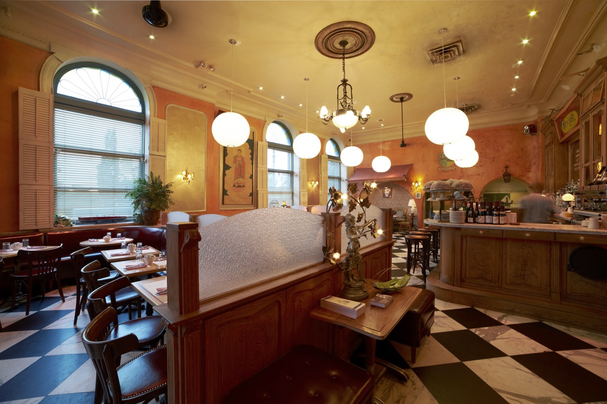A wide dining room with globe pendant lights and a chandelier