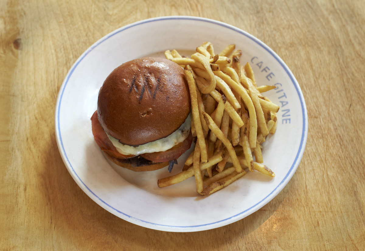 A burger and fries on a Cafe Gitane plate