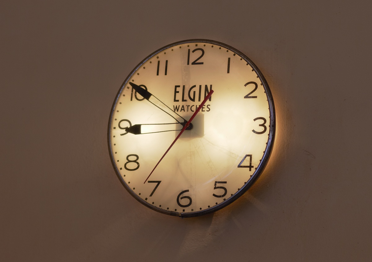 An Elgin wall clock on a plain wall