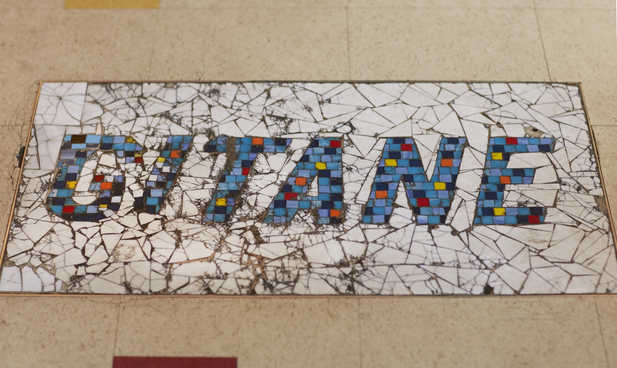 A mosaic tile threshold spelling out the word GITANE